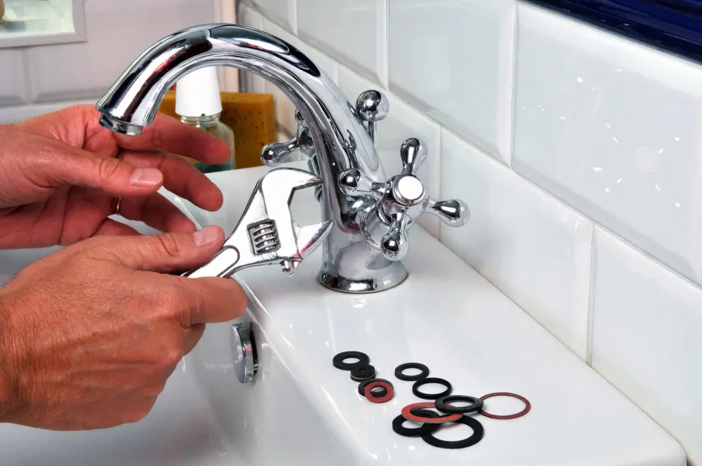 Plumber performing maintenance on a bathroom faucet in Ontario