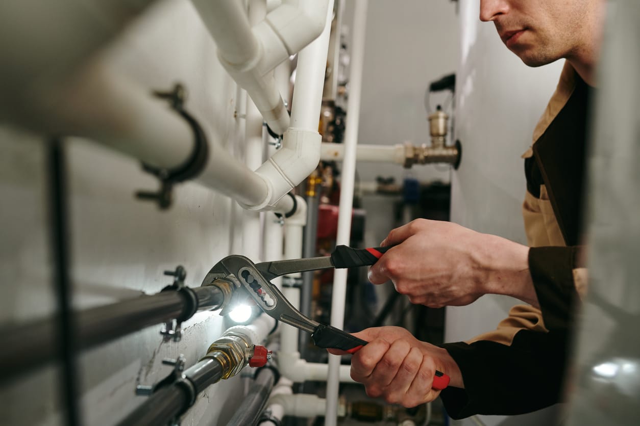 Plumbers maintaining commercial plumbing pipes in Ontario