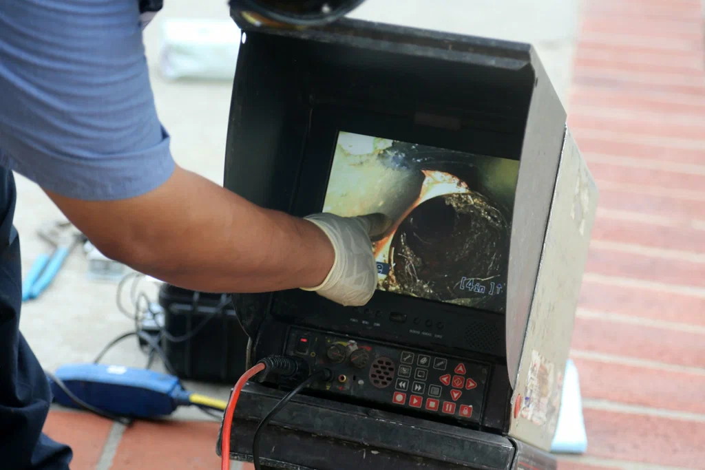 Technician viewing a drain inspection camera in Ontario