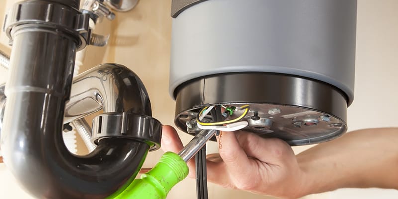 Technician repairing the heating element of a water heater in Ontario